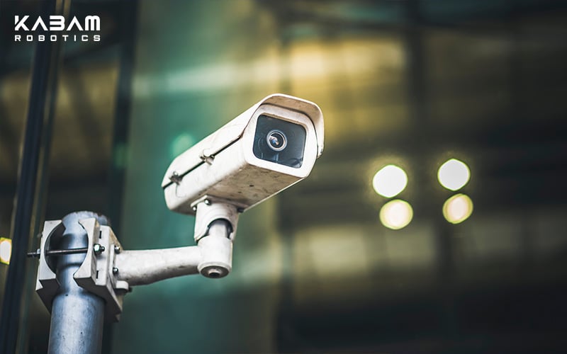 Close-up of a security CCTV camera mounted on a pole